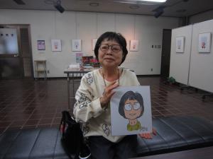 似顔絵イベントの様子です。似顔絵ににっこり。