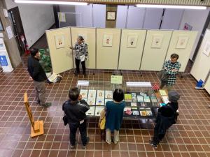 この写真は内藤勲の似顔エッセイ展の解説風景です。