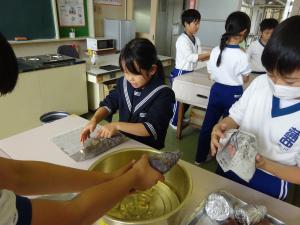 いもをアルミホイルで巻いている写真です