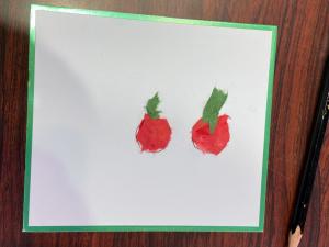 この写真はミニトマトを和紙ちぎり絵にしたものです。