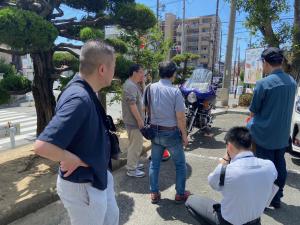 この写真は図書館の駐車場に集まる人たちの様子です。